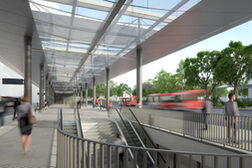 Auf der Visualisierung ist die große und breite Mittelinsel mit transparentem Dach und den Rolltreppen hinab zum Bahnhof zu sehen.