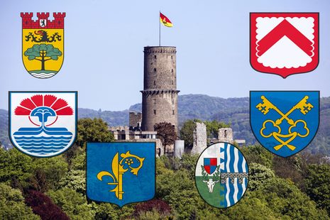 Foto der Godesburg und die Wappen der Partnerstädte Steglitz-Zehlendorf, Windsor-Maidenhead, Frascati, Saint-Cloud, Yalova und Kortrijk.