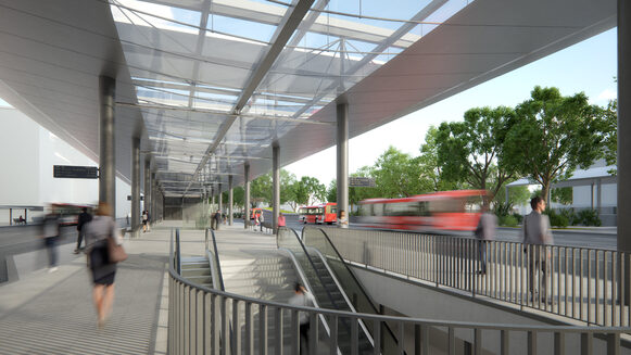 Diese Ansicht zeigt den Wartebereich mit transparentem Dach und dem Zugang zum Bahnhof.