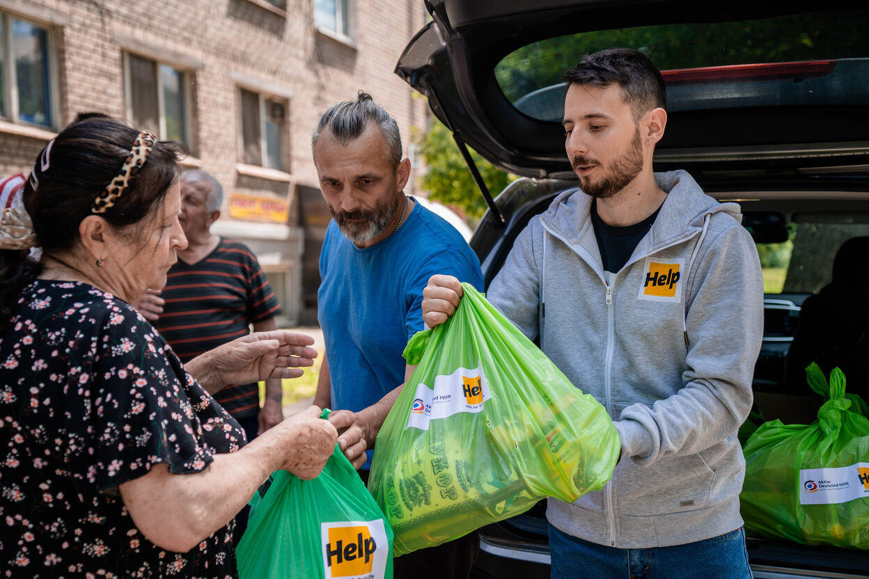 Das Bild zeigt die Übergabe von Spenden durch Mitarbeitende von Help an Menschen in der Ukraine.