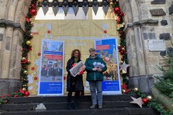 Das Bild zeigt Melanie von Seht, Leiterin der Bonn-Information, und ihre Stellvertreterin Birgit Landsberg vor dem weihnachtlich geschmückten Sterntor. Sie präsentieren das Tourenprogramm für die kommende Saison 2023.