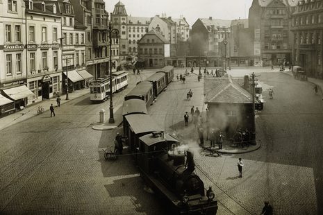 Bild vom früheren Friedensplatz, durch den eine Lokomotive fährt
