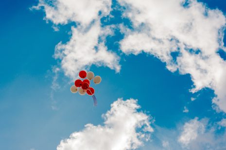 Luftballons am blauen Himmel mit Wolken